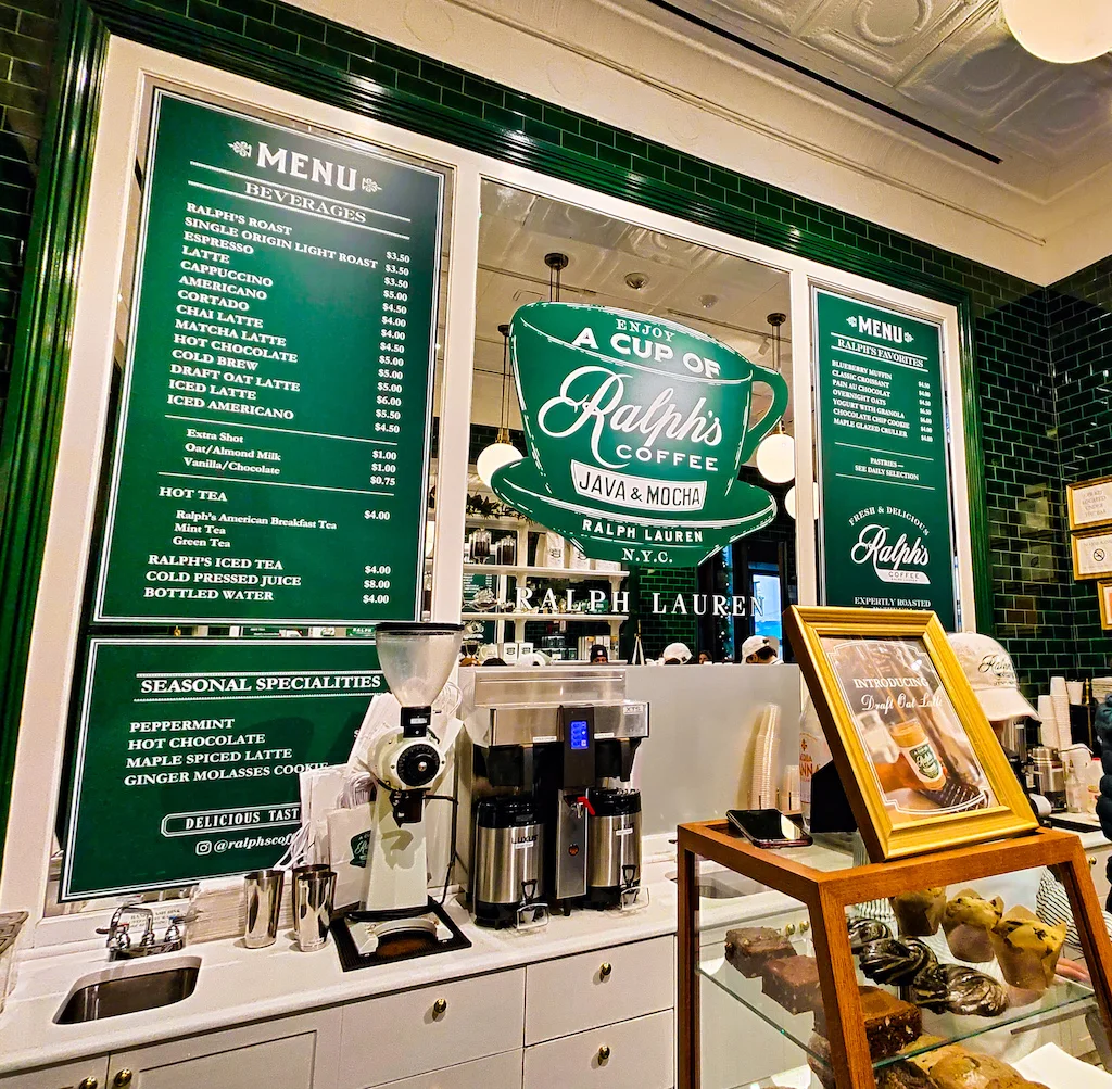 Green and white decor inside Ralph's Coffee and a pick for best cafes Upper East Side. 