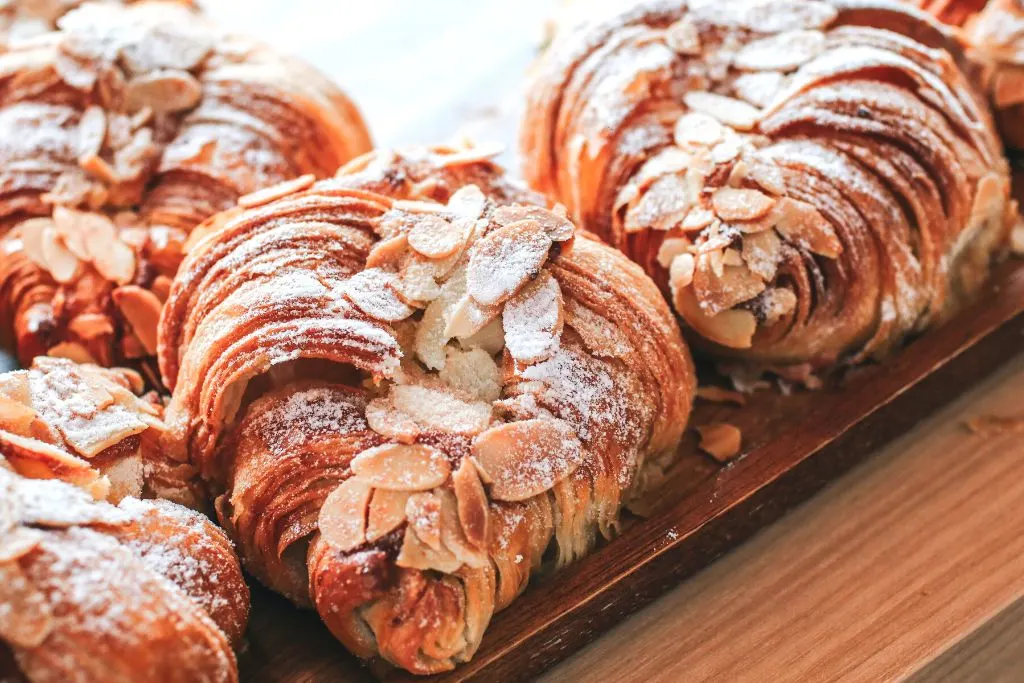 Vegan almond croissants on a cutting board from one of the best vegan bakeries NYC has to offer. 