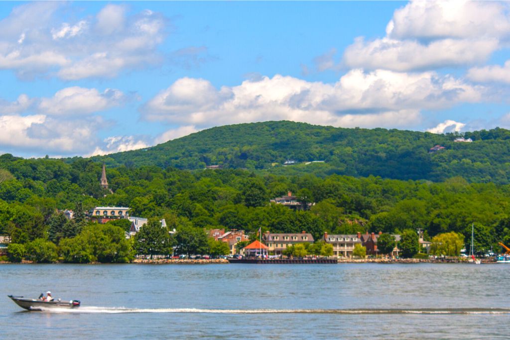 View of West Point Foundry Preserve from the Hudson River as a boat passes by. 