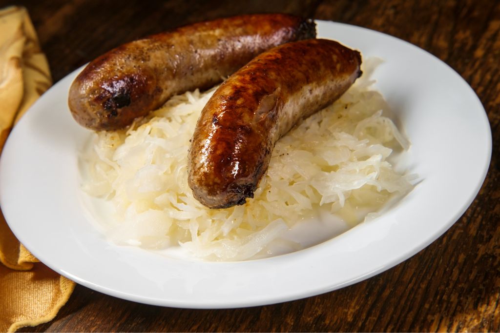 Two sausages on a plate from one of the best happy hours in NYC. 