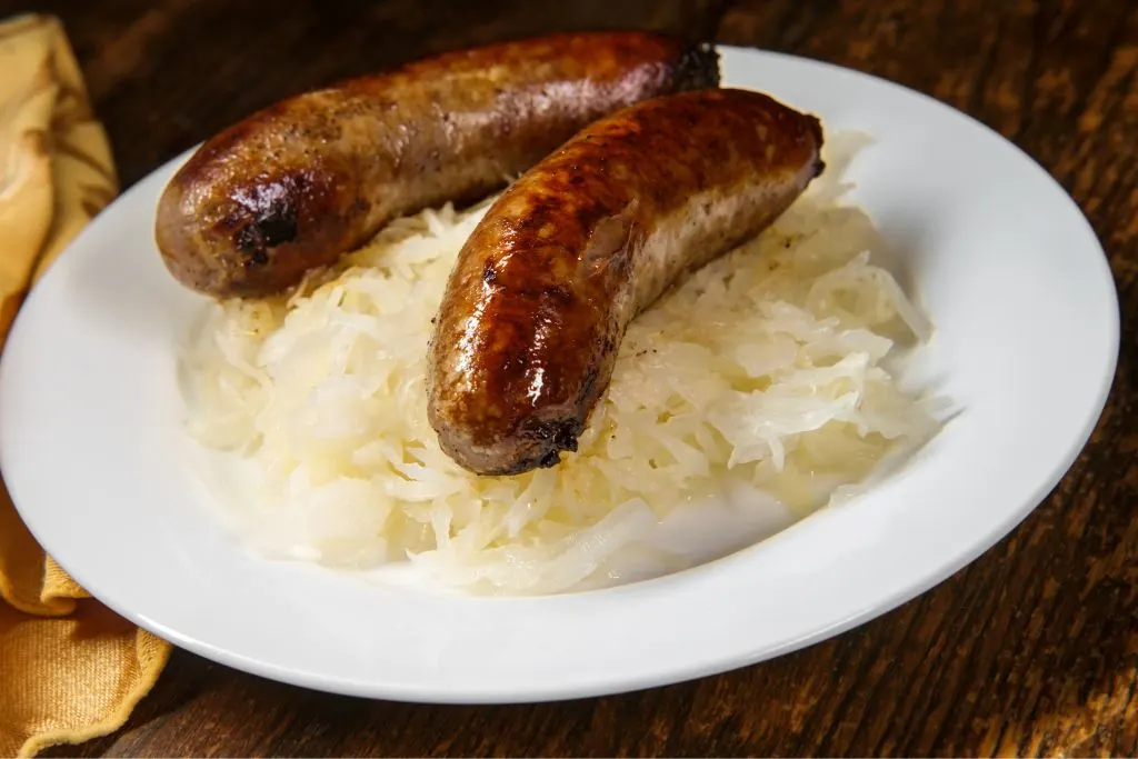 Two sausages on a plate from one of the best happy hours in NYC. 