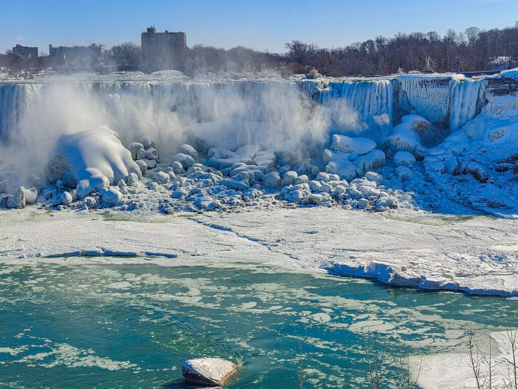 Viw of Niagara Falls in the winter with tons of snow and ice at Niagar Falls on the US side. 