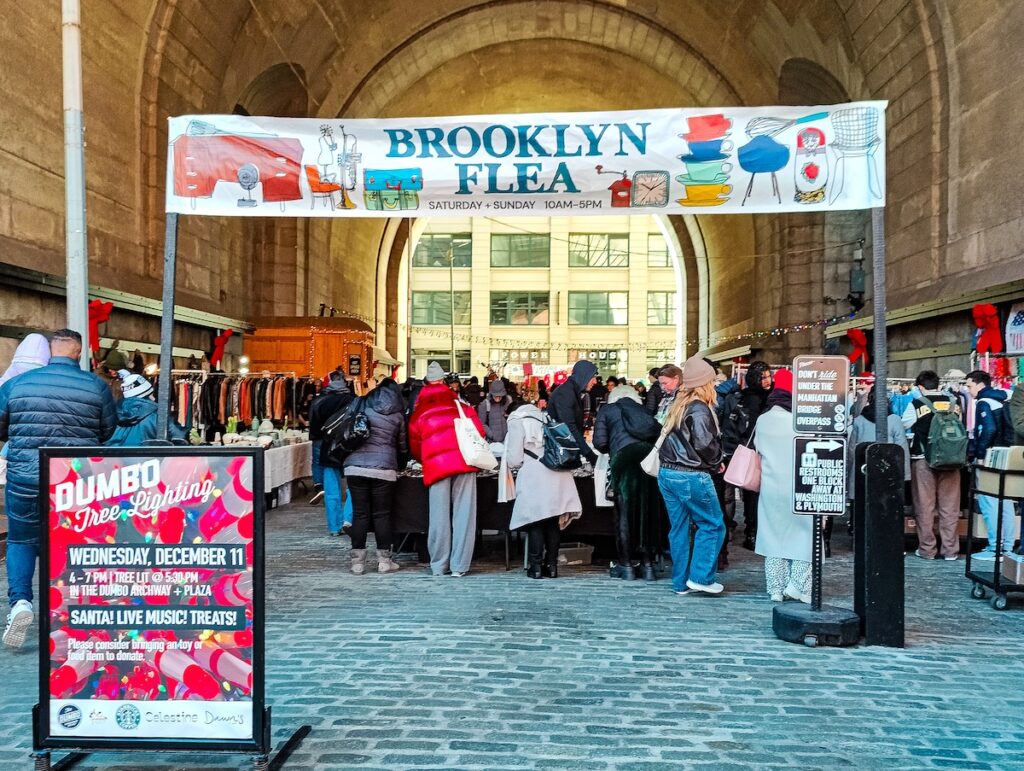View of people shopping underneath the bridge at Brooklyn Flea.