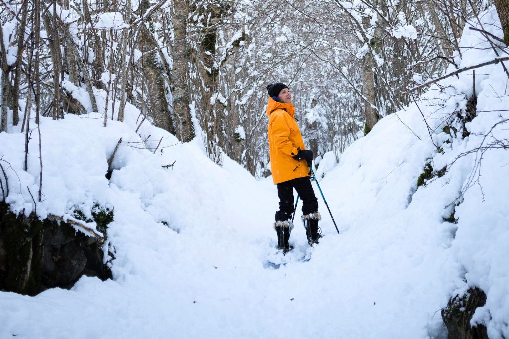 Women snow shoeing through the snow. 