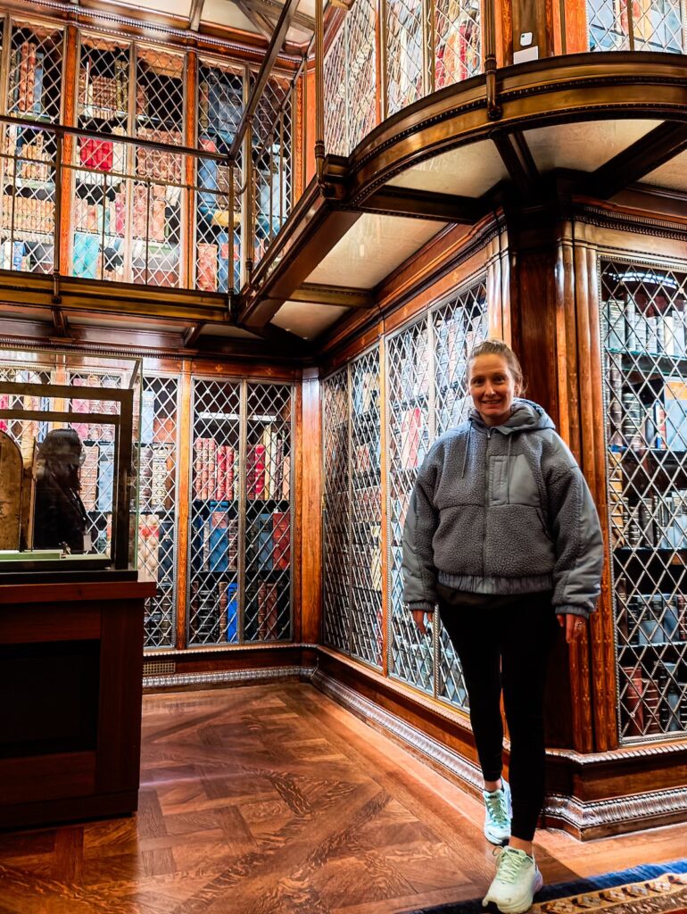 Me standing in ablue fleece and black leggings at the Morgan Library. 
