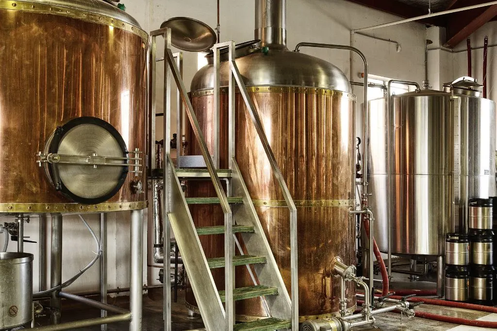 Large metal drums used to brew beer at one of the best breweries in Brooklyn. 