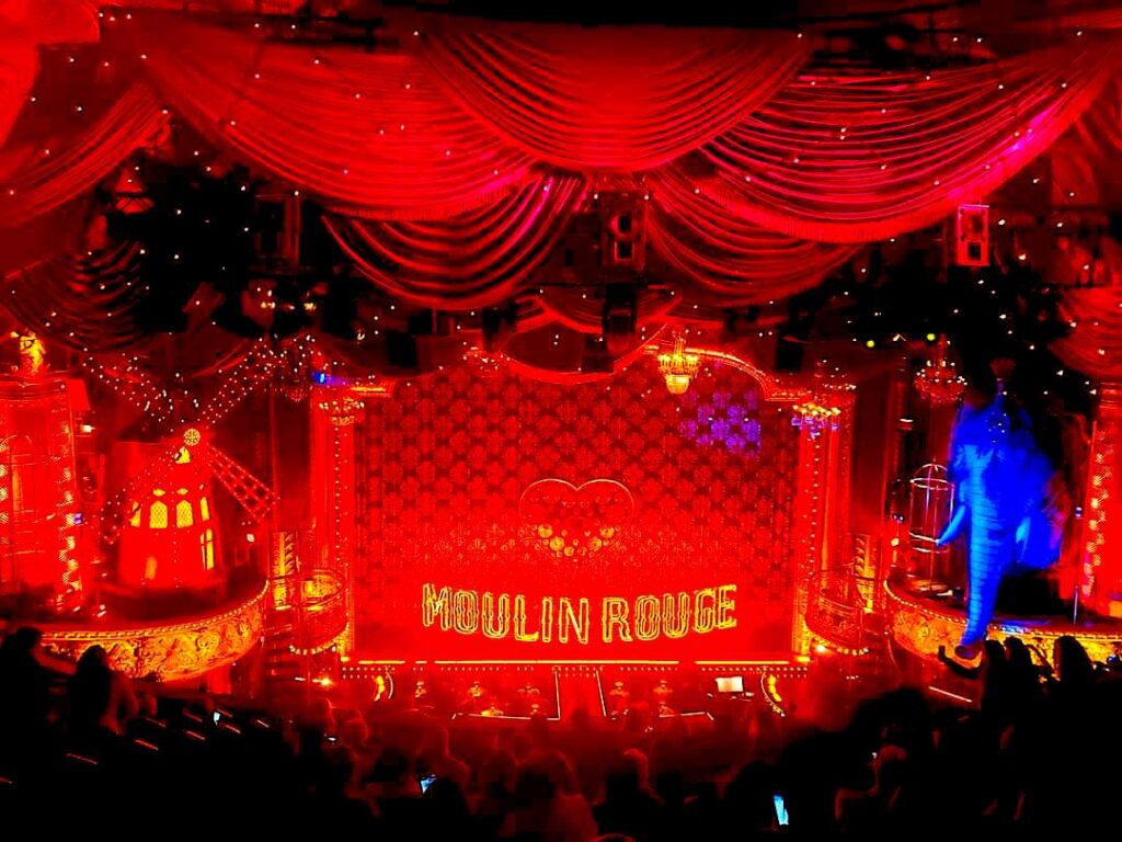 View of the elaborate red stage with a windmill and an elephant for Moulin Rouge in NYC.